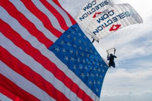 A member of Team Fastrax performs with an American Flag