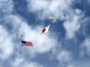 Skydive members perform with American Flag and Japanese Flag.