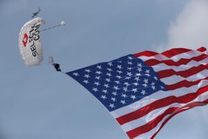 Team Fastrax™ member performs with a 2,000 sq. ft. American Flag.